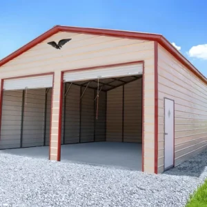 A 24X30X12 Vertical Roof Metal Garage with a metal roof and two doors, located in a grassy field.