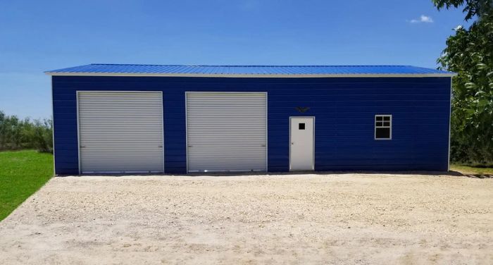 A blue metal garage with a white door from Bargain Metal Buildings.