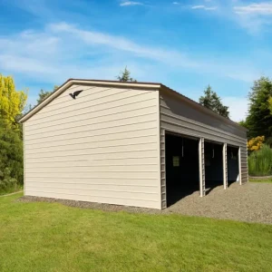 A yard with trees and grass houses a 26X40X12 Vertical Roof Metal Garage.