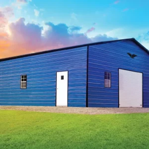 A 28X35X11 Vertical Roof Metal Garage in a grassy field.
