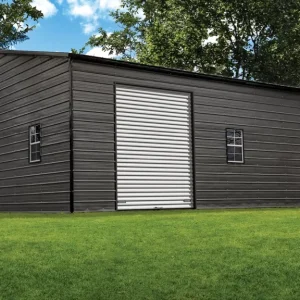 A black metal shed in a grassy yard. The 28X45X11 Vertical Roof Metal Garage is also available.