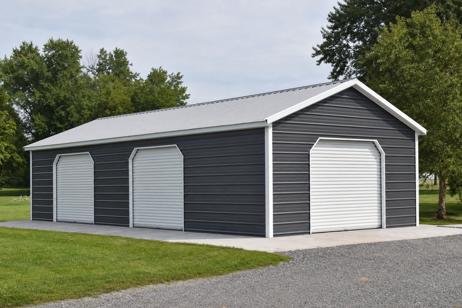 Large dark gray metal garage with three white roll-up doors