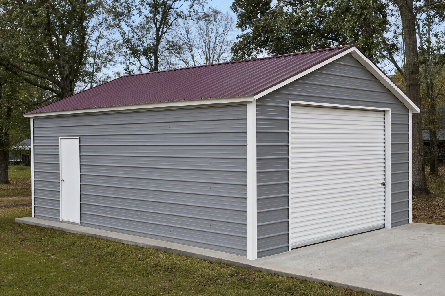 Gray metal garage with red roof and white roll-up door