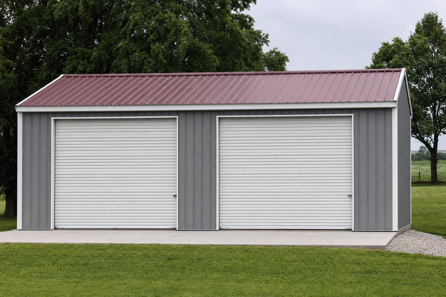 Two-car metal garage with red roof on green lawn
