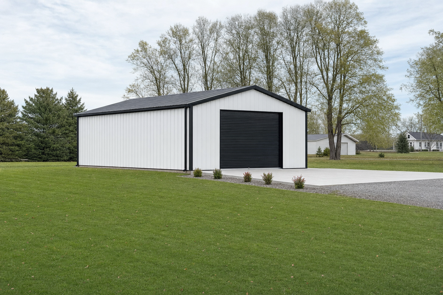 Modern white metal pole barn with black roll-up door