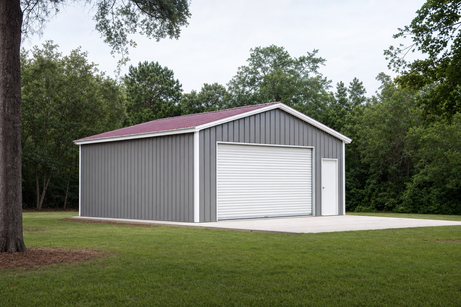 Gray metal garage building with red roof and white doors