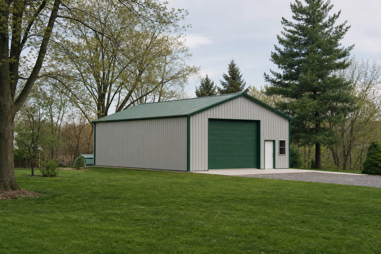 Large metal pole barn with green roof on rural property
