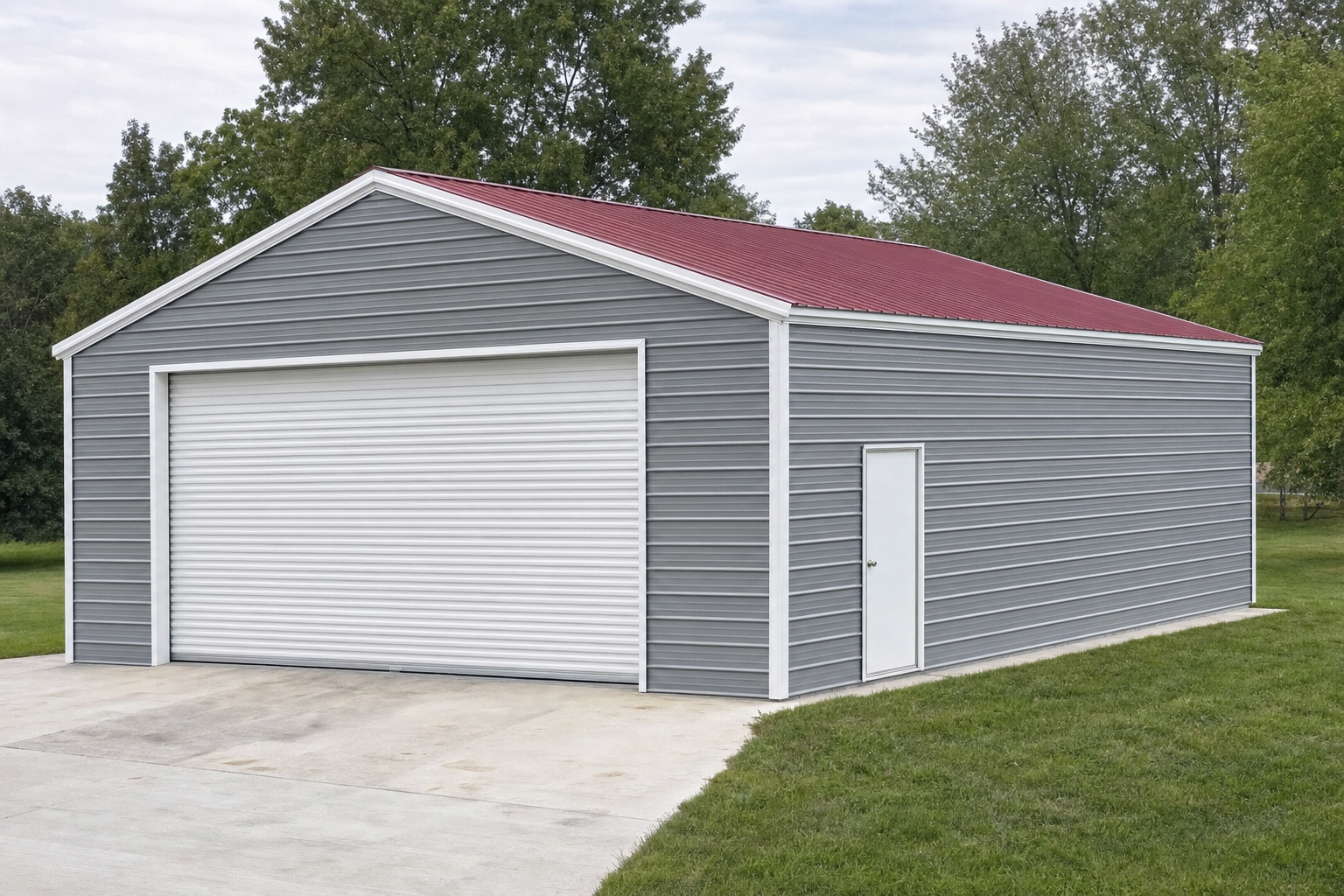 Gray metal garage with red roof and white roll-up door