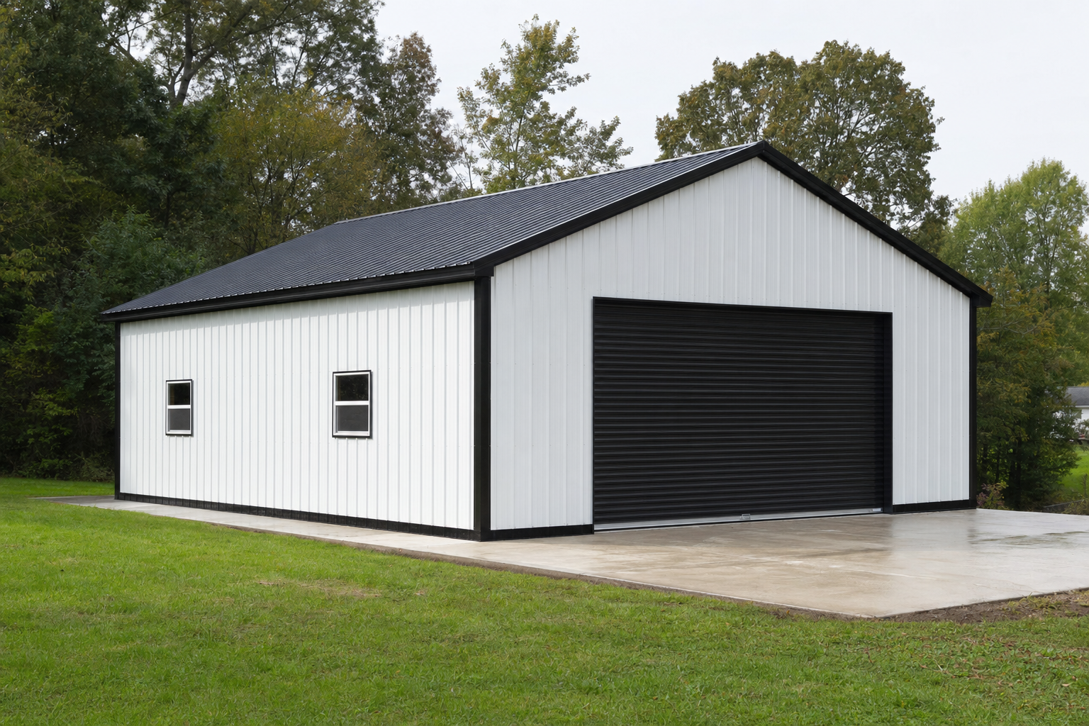 Modern white metal garage building with black roof and door