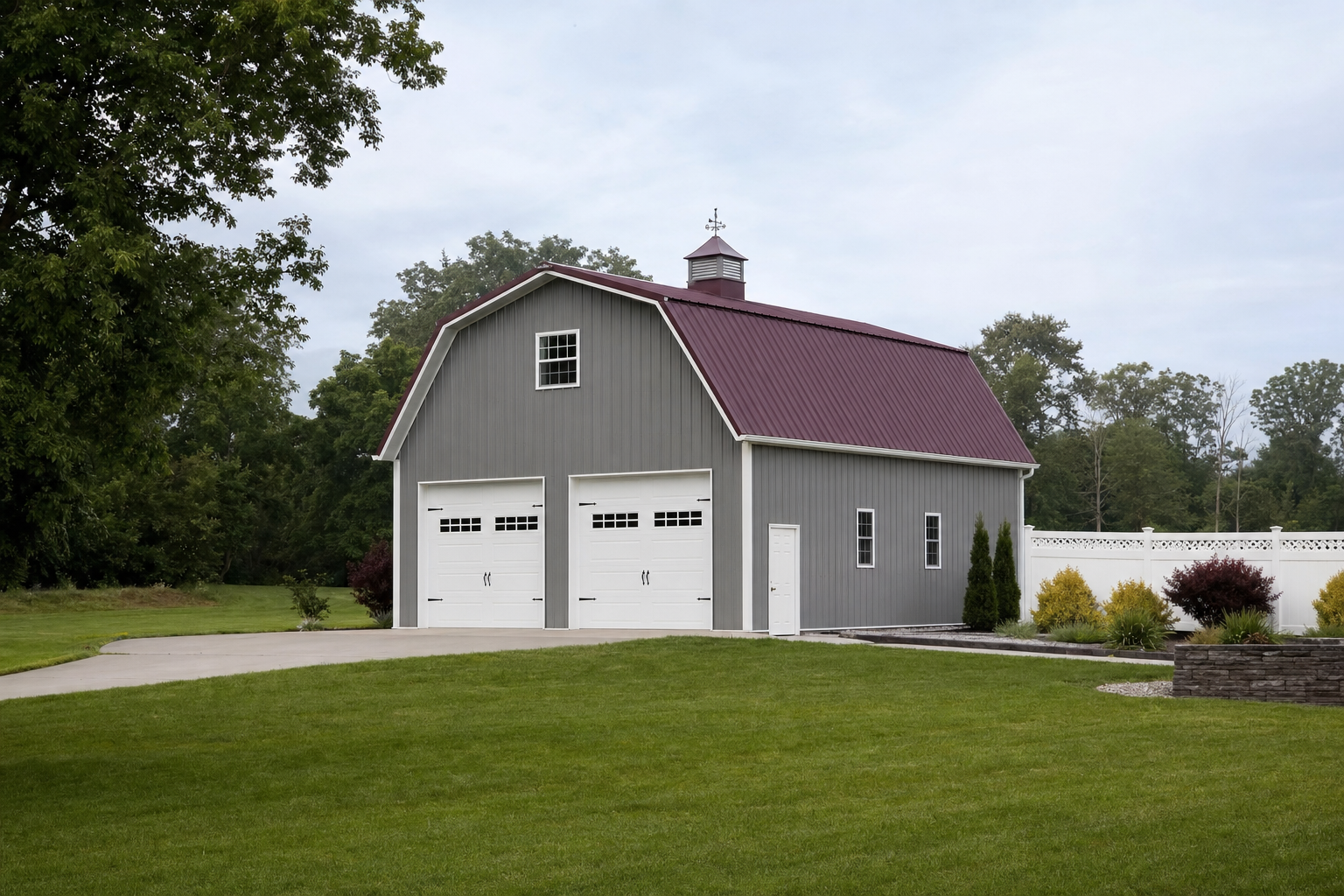 Gray barn-style garage with red roof and cupola